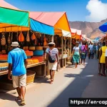 카보베르데 여행자 대상 범죄 - A vibrant street market scene in Cape Verde during daytime, featuring diverse tourists browsing colo...